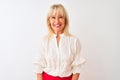 Middle age businesswoman wearing elegant shirt standing over isolated white background with a happy and cool smile on face