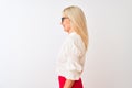 Middle age businesswoman wearing shirt and glasses standing over isolated white background looking to side, relax profile pose Royalty Free Stock Photo