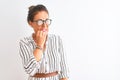 Middle age businesswoman wearing striped dress and glasses over isolated white background looking stressed and nervous with hands Royalty Free Stock Photo