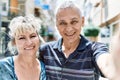 Middle age caucasian couple of husband and wife together on a sunny day outdoors Royalty Free Stock Photo