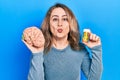 Middle age caucasian woman holding brain and pills as mental health concept looking at the camera blowing a kiss being lovely and Royalty Free Stock Photo