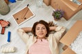 Middle age caucasian woman relaxed lying on the floor at new home Royalty Free Stock Photo