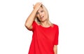Middle age caucasian woman wearing casual clothes surprised with hand on head for mistake, remember error Royalty Free Stock Photo