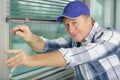 Middle age contractor fixing window blinds