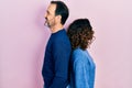 Middle age couple of hispanic woman and man hugging and standing together looking to side, relax profile pose with natural face Royalty Free Stock Photo