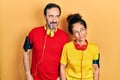 Middle age couple of hispanic woman and man wearing sportswear and arm band smiling looking to the side and staring away thinking Royalty Free Stock Photo