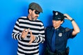 Middle age couple of hispanic woman and man wearing thief and police uniform confuse and wondering about question