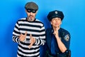 Middle age couple of hispanic woman and man wearing thief and police uniform thinking concentrated about doubt with finger on chin