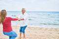 Middle age couple in love dancing at the beach happy and cheerful together Royalty Free Stock Photo