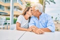 Middle age couple in love sitting at the terrace of coffee shop kissing happy and cheerful together Royalty Free Stock Photo