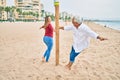 Middle age couple in love walking having fun ath the beach happy and cheerful together Royalty Free Stock Photo