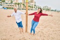 Middle age couple in love walking having fun ath the beach happy and cheerful together Royalty Free Stock Photo