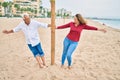 Middle age couple in love walking having fun at the beach happy and cheerful together Royalty Free Stock Photo