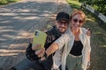 Middle age couple riding a motorcycle having fun and taking a selfie on a mobile phone camera Royalty Free Stock Photo