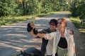 Middle age couple riding a motorcycle having fun and taking a selfie on a mobile phone camera Royalty Free Stock Photo