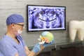 Middle age dentist preparing treatment plan in his office Royalty Free Stock Photo