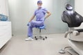 Middle age,dentist stretching legs and lower back sitting on dental saddle