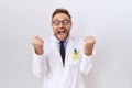 Middle age doctor man with beard wearing white coat celebrating surprised and amazed for success with arms raised and open eyes Royalty Free Stock Photo