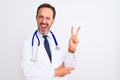 Middle age doctor man wearing coat and stethoscope standing over isolated white background smiling with happy face winking at the Royalty Free Stock Photo