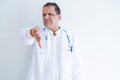 Middle age doctor man wearing stethoscope and medical coat over white background looking unhappy and angry showing rejection and Royalty Free Stock Photo