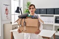 Middle age doctor woman holding cardboard box with items at the clinic skeptic and nervous, frowning upset because of problem Royalty Free Stock Photo
