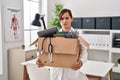 Middle age doctor woman holding cardboard box with items at the clinic skeptic and nervous, frowning upset because of problem Royalty Free Stock Photo