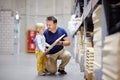 Middle age father with little boy choosing the right furniture for their apartment in a modern home furniture store Royalty Free Stock Photo