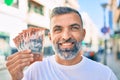 Middle age grey-haired man smiling happy holding australian dollars banknotes standing at the city Royalty Free Stock Photo