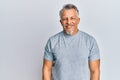 Middle age grey-haired man wearing casual clothes with a happy and cool smile on face