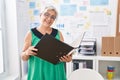 Middle age grey-haired woman business worker reading document at office Royalty Free Stock Photo