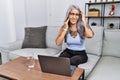 Middle age grey-haired woman using laptop at home touching mouth with hand with painful expression because of toothache or dental Royalty Free Stock Photo