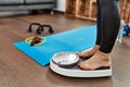 Middle age grey-haired woman using weighing machine at home Royalty Free Stock Photo