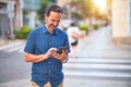 Middle age handsome businessman using tablet smiling on the street Royalty Free Stock Photo