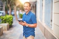 Middle age handsome businessman using tablet smiling on the street Royalty Free Stock Photo