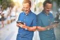 Middle age handsome businessman using tablet smiling on the street Royalty Free Stock Photo