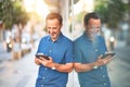 Middle age handsome businessman using tablet smiling on the street Royalty Free Stock Photo