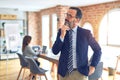 Middle age handsome businessman wearing glasses   standing at the office with hand on chin thinking about question, pensive Royalty Free Stock Photo