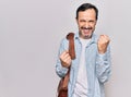 Middle age handsome businessman wearing leather bag over isolated white background celebrating surprised and amazed for success Royalty Free Stock Photo