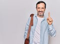 Middle age handsome businessman wearing leather bag over isolated white background smiling with an idea or question pointing Royalty Free Stock Photo