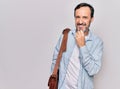 Middle age handsome businessman wearing leather bag over isolated white background smiling looking confident at the camera with Royalty Free Stock Photo