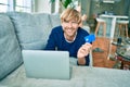 Middle age handsome caucasian man relaxing at home doing online shopping using credit card on computer laptop Royalty Free Stock Photo