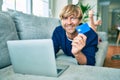 Middle age handsome caucasian man relaxing at home doing online shopping using credit card on computer laptop Royalty Free Stock Photo