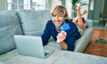 Middle age handsome caucasian man relaxing at home doing online shopping using credit card on computer laptop Royalty Free Stock Photo