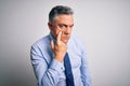 Middle age handsome grey-haired business man wearing elegant shirt and tie Pointing to the eye watching you gesture, suspicious Royalty Free Stock Photo