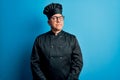 Middle age handsome grey-haired chef man wearing cooker uniform and hat smiling looking to the side and staring away thinking Royalty Free Stock Photo