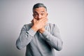 Middle age handsome grey-haired man wearing casual t-shirt over white background shocked covering mouth with hands for mistake Royalty Free Stock Photo