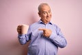 Middle age handsome hoary man drinking mug of coffee over isolated pink background very happy pointing with hand and finger