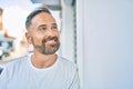 Middle age handsome man smiling happy leaning on the wall at the city Royalty Free Stock Photo