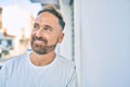 Middle age handsome man smiling happy leaning on the wall at the city Royalty Free Stock Photo