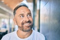 Middle age handsome man smiling happy leaning on the wall at the city Royalty Free Stock Photo